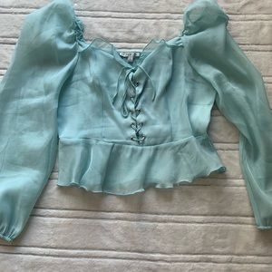 Size L. Crop top, back of blouse has stretch to it also adjustable front